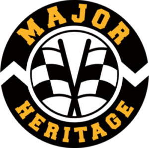 This is the logo for Major Heritage. It is a roundel with two crossed chequered flags in the center and the words Major above and Heritage below around the edge of the circle.