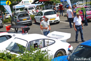 people in the nurburgring car park in the sunshine